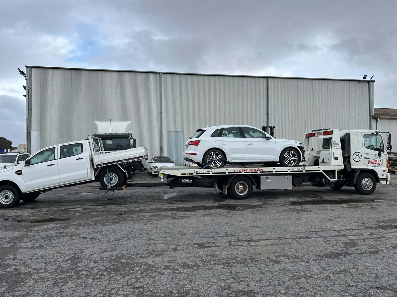 White Audi Q5 on the SA Best Towing tray with a white Ford Ranger ute on the rear lift